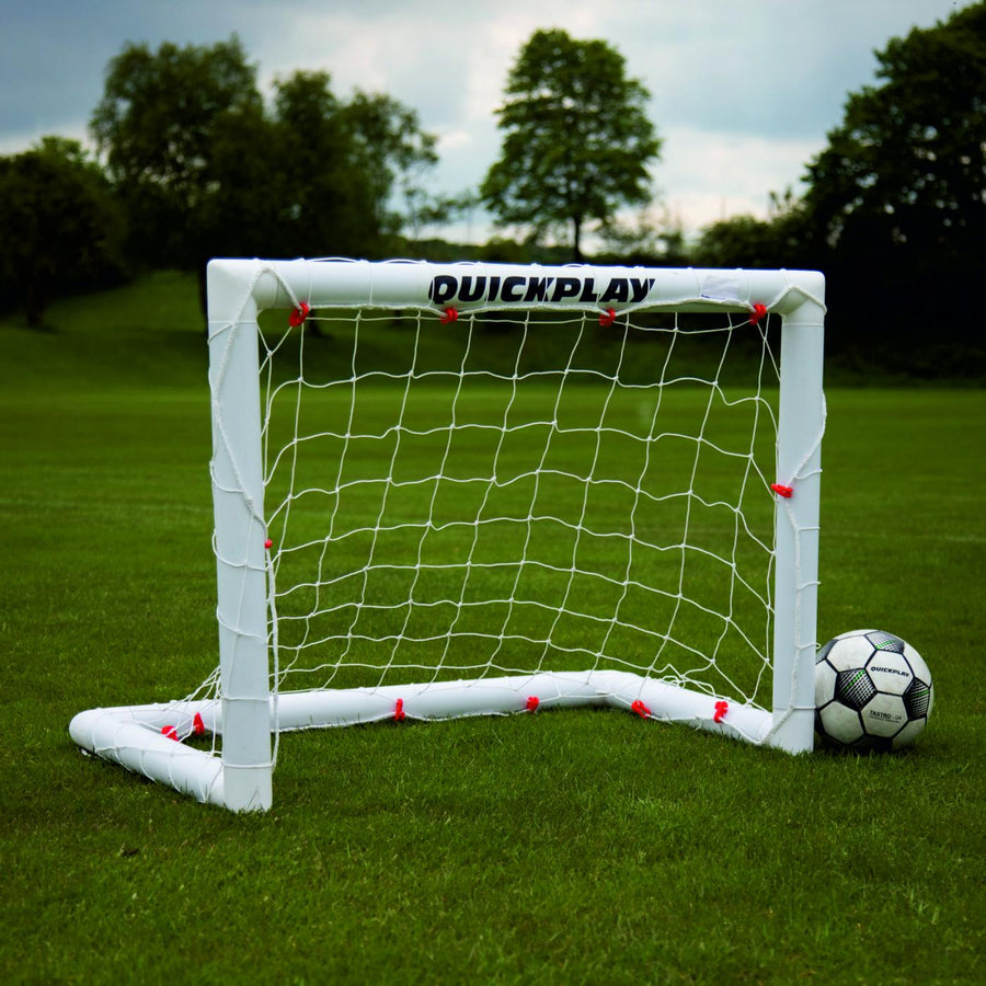Q-FOLD Mini Football Goal 90 x 75 cm with a white frame and net on grass, with a football beside it.