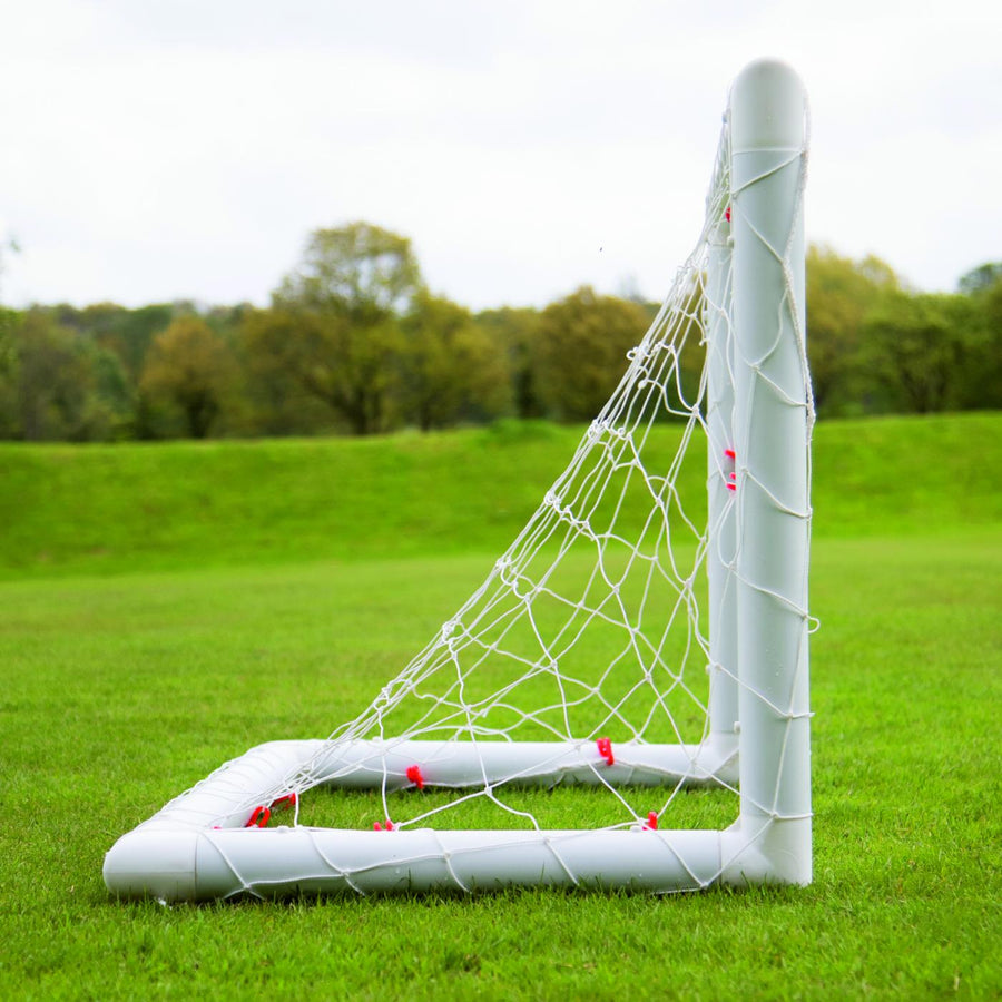 Q-FOLD Mini Football Goal 90 x 75 cm from the side on grass, showing the depth of the net.