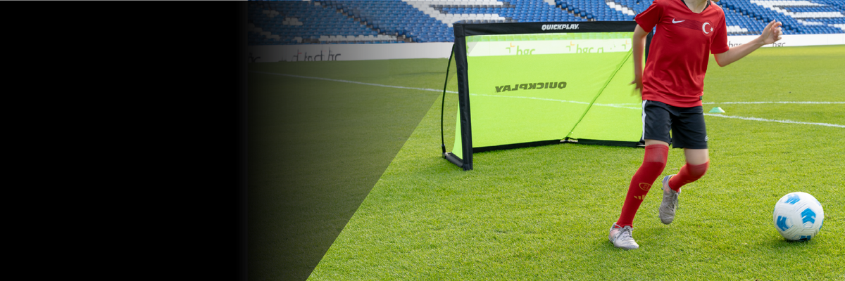 Young footballer playing with a KICKSTER PRO goal