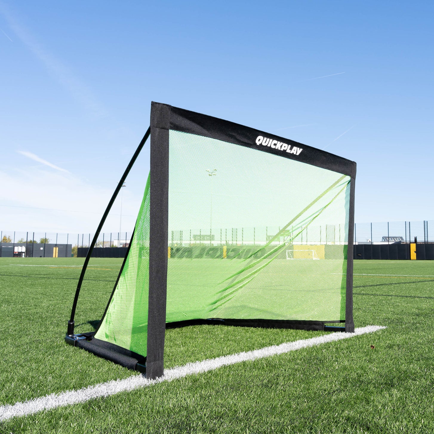 KICKSTER PRO 120 x 75 cm goal on an artificial pitch, front three-quarter view with QUICKPLAY on the crossbar sleeve.