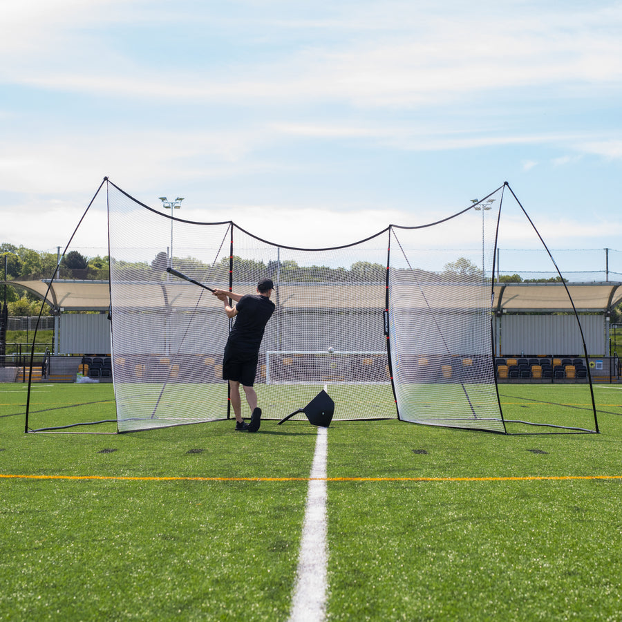 Batter swinging inside a U-shaped MEGA NET setup, seen from the front, with the Extender Net 240 x 270 cm as the centre section.