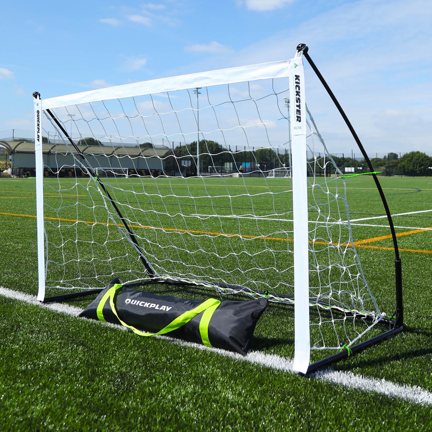 KICKSTER Elite 150 x 100 cm goal on an artificial pitch, with its black QUICKPLAY carry bag in front.