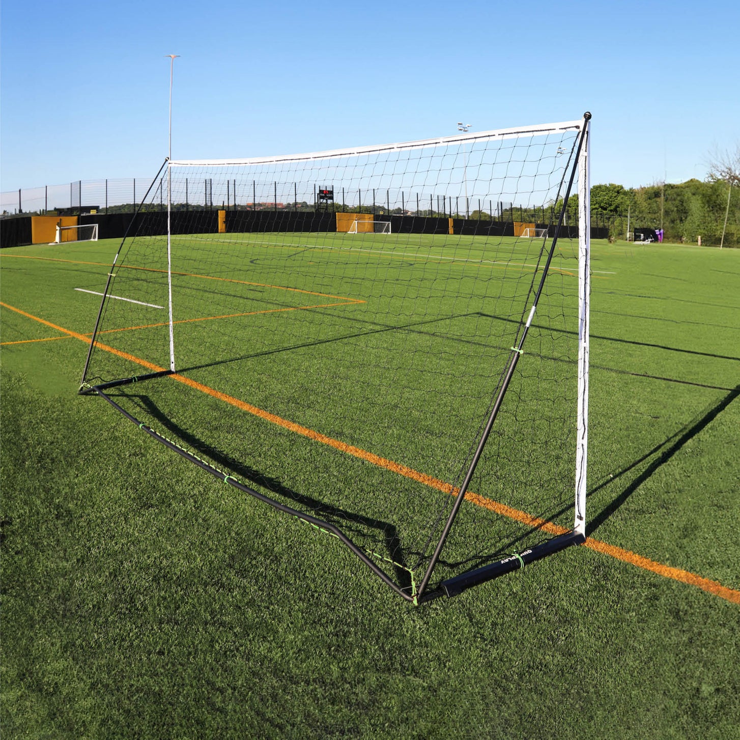 KICKSTER Elite 500 x 200 cm goal from behind on an artificial pitch, showing the black back frame and the net.