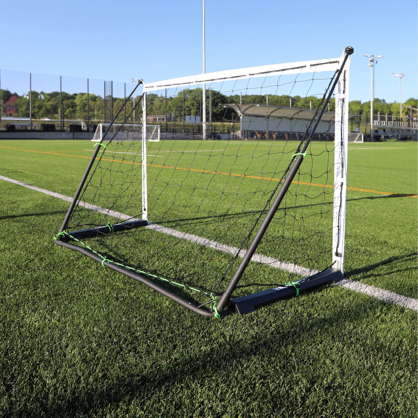 KICKSTER Elite 180 x 120 cm goal from behind on an artificial pitch, showing the black back frame and net clips.