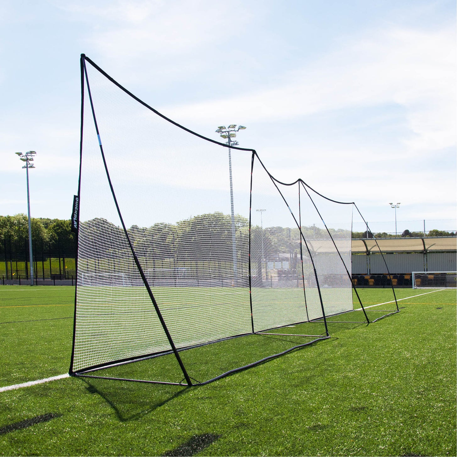 MEGA NET 370 x 270 cm ball-stop set up in a long row with a second net along the edge of an artificial pitch.
