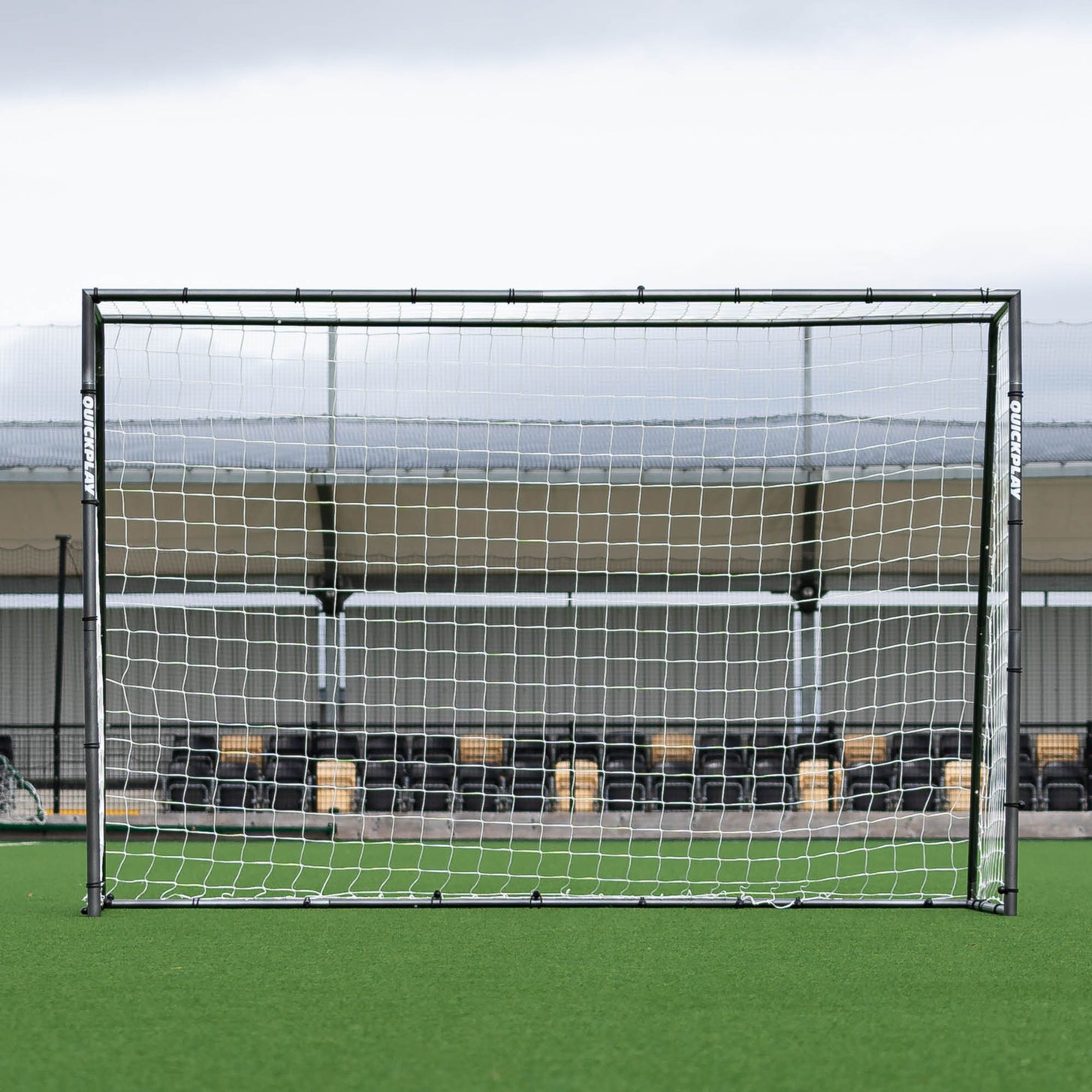 GS Series Futsal Goal 300 x 200 cm seen straight on, in front of a stand at an artificial pitch.