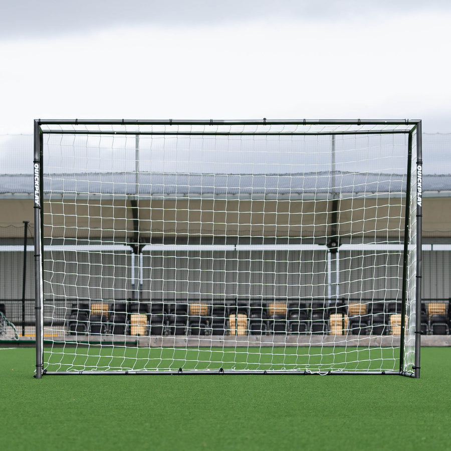 GS Series Futsal Goal 300 x 200 cm seen straight on, in front of a stand at an artificial pitch.