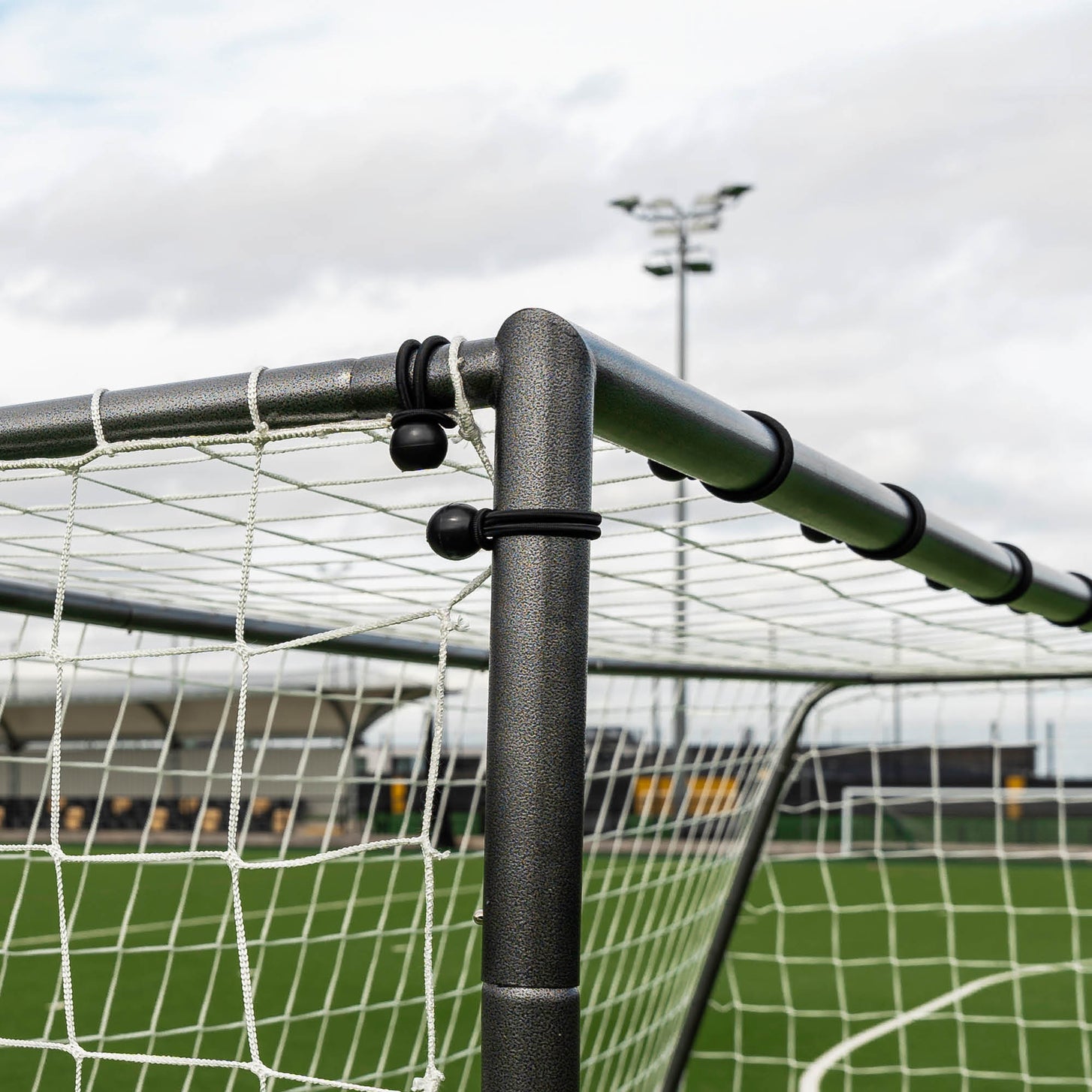 GS Series Futsal Goal 300 x 200 cm close-up of a top corner, with black ball bungees holding the white net to the frame.