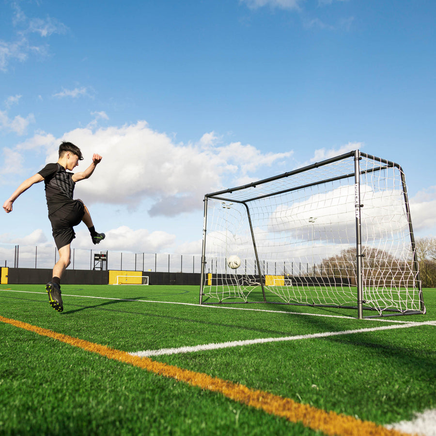 Player shooting at the GS Series Futsal Goal 300 x 200 cm on an artificial pitch, with the ball flying into the net.