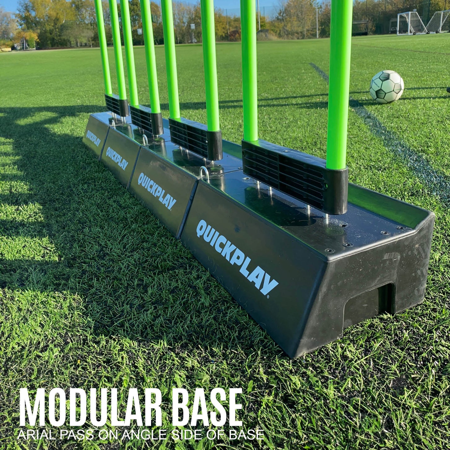 REPLAY Defender & Block System modular base: several black QUICKPLAY bases joined in a line, with green mannequin poles fitted.