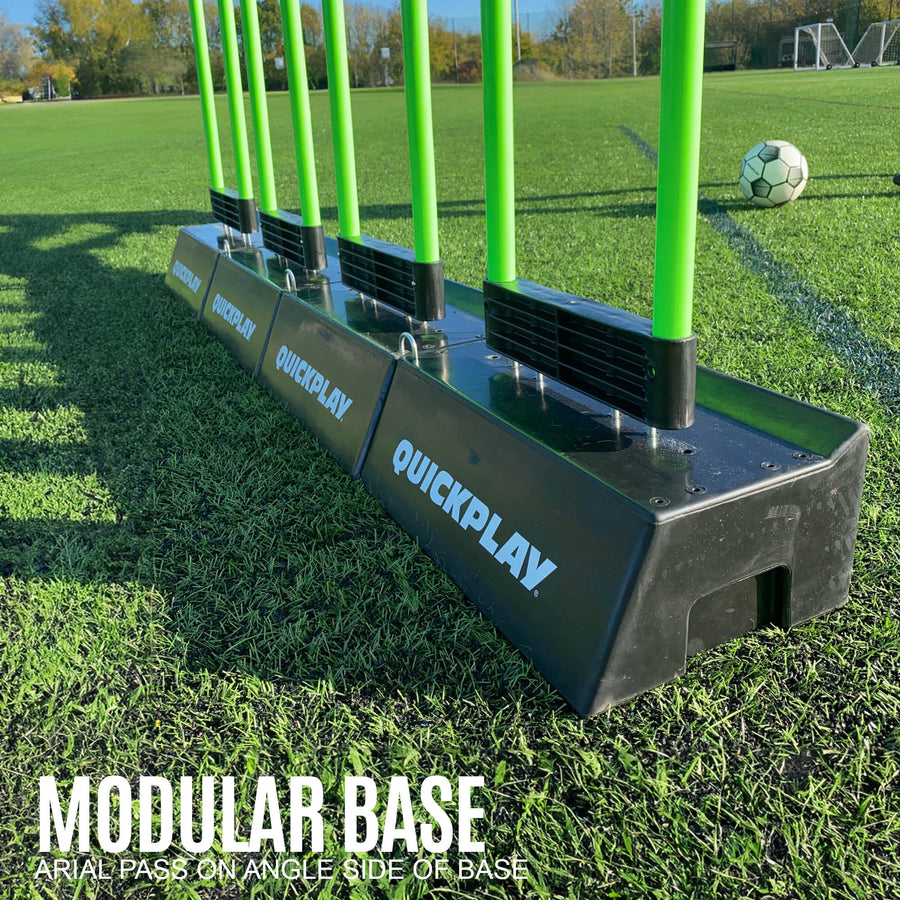 REPLAY Defender & Block System modular base: several black QUICKPLAY bases joined in a line, with green mannequin poles fitted.